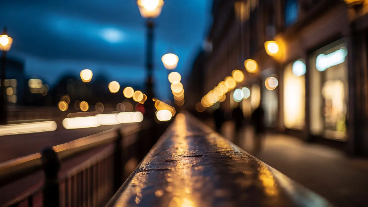 Low-angle South Bank street scene with glowing bokeh lights and wet pavement at blue hour